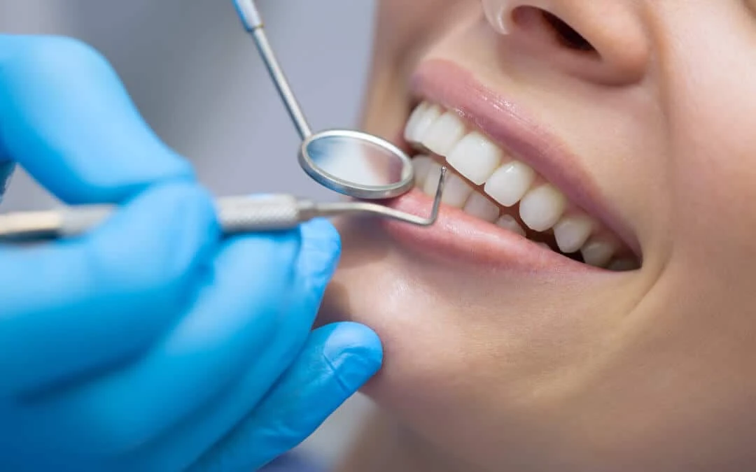Dentist examining a patient’s teeth with a dental mirror